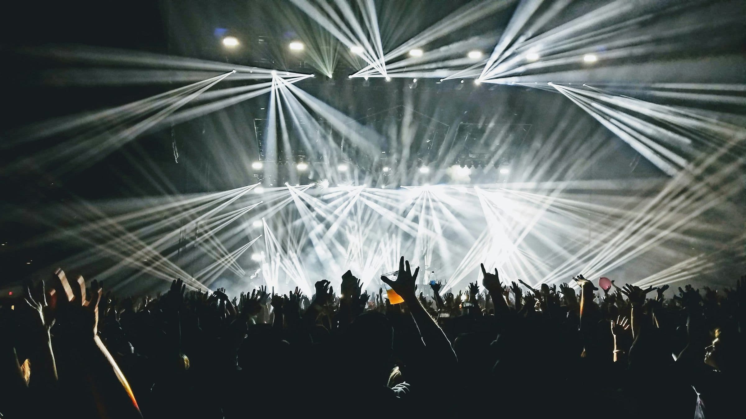 Beams of light above a packed hall.