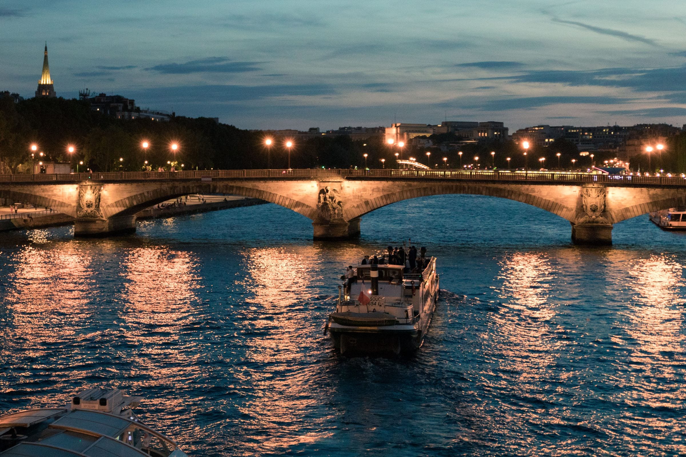 The Seine after dark, a lit bridge and the embankments.
