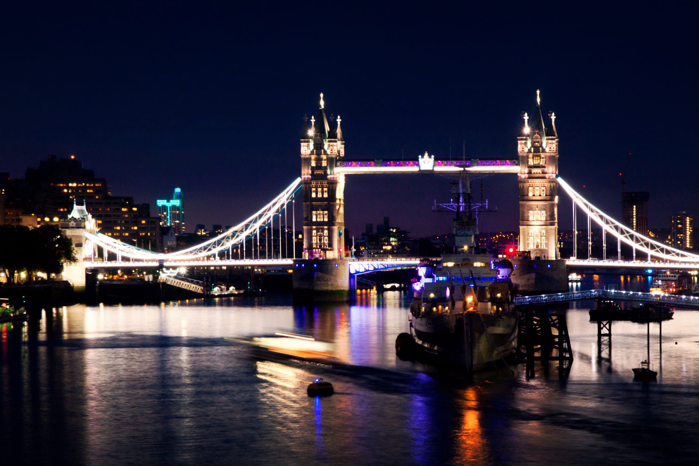 London at blue hour, the Thames and its lit bridges.