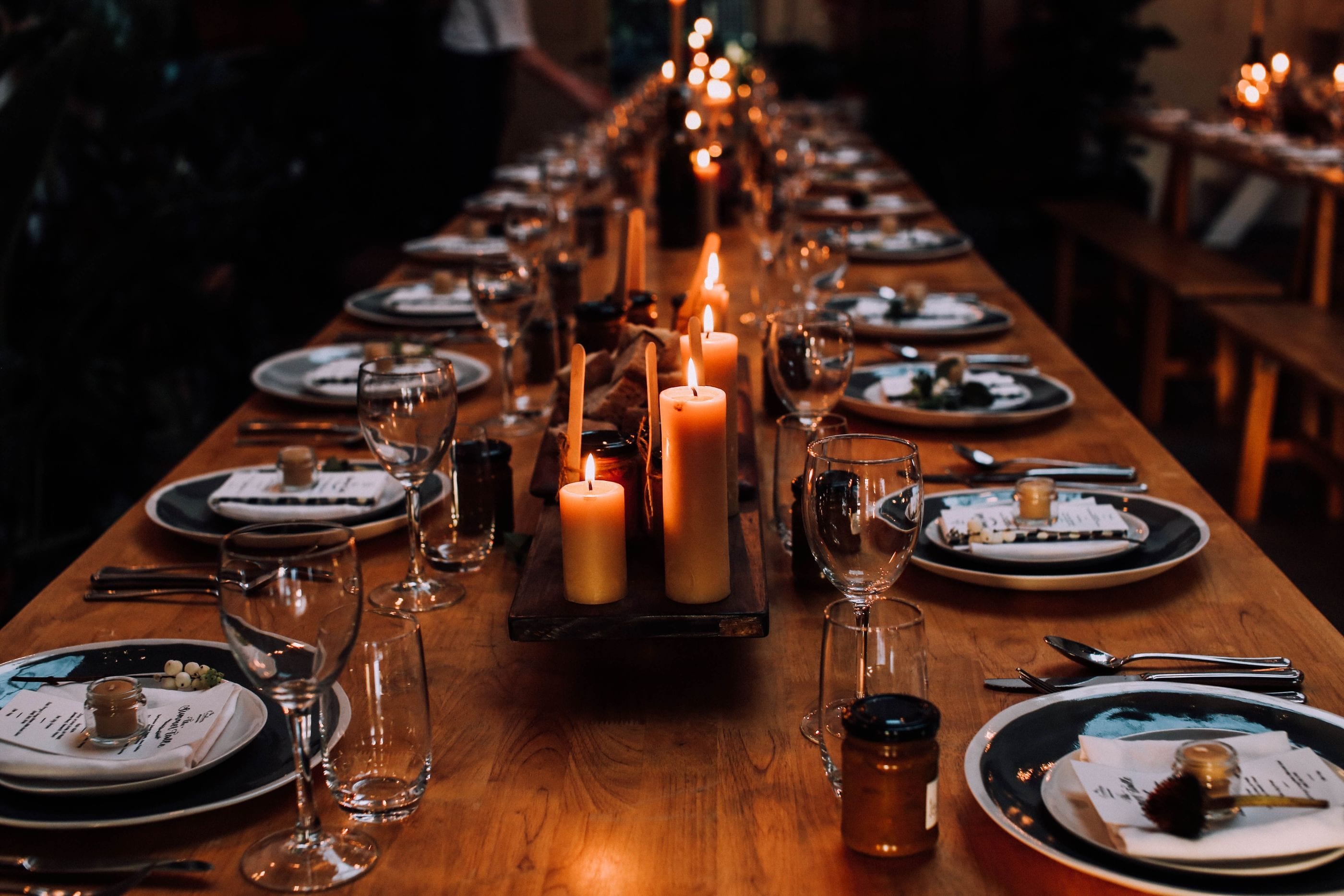 A long private dinner table set with candles.