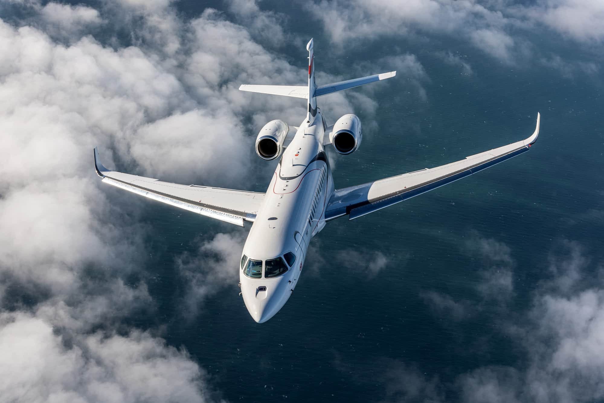 A business jet above a sea of clouds.