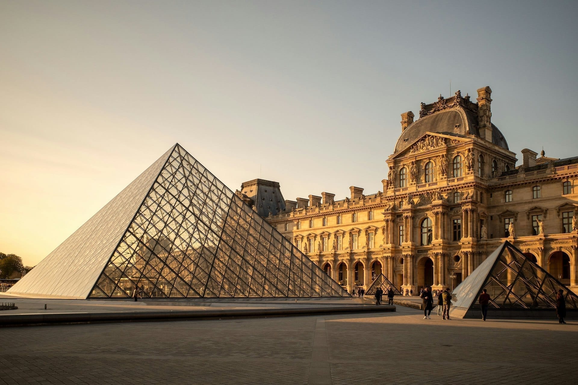 The Louvre pyramid and the Cour Napoléon at golden hour.