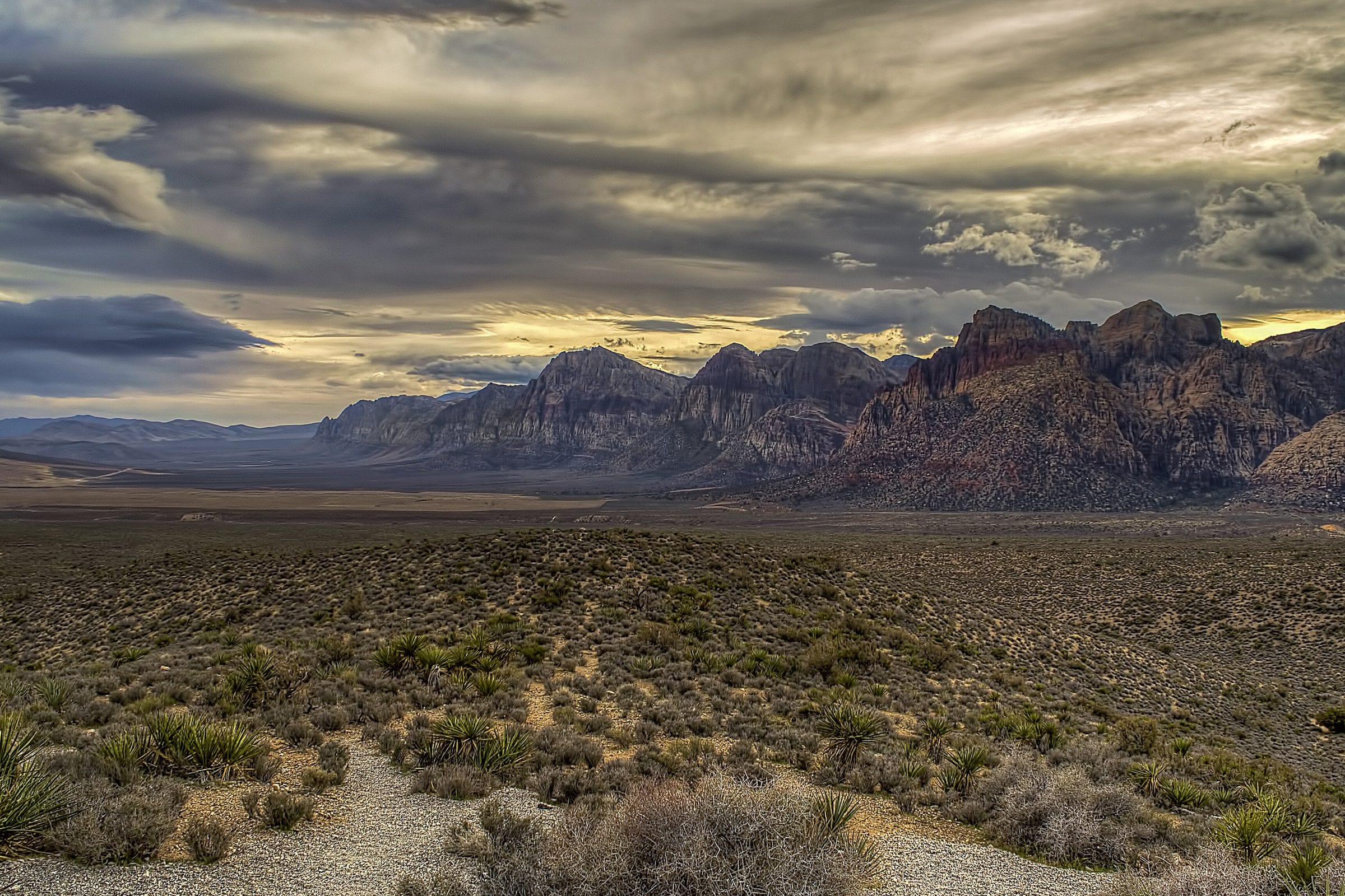 The Nevada desert at dusk, sagebrush plain running to the mountains.