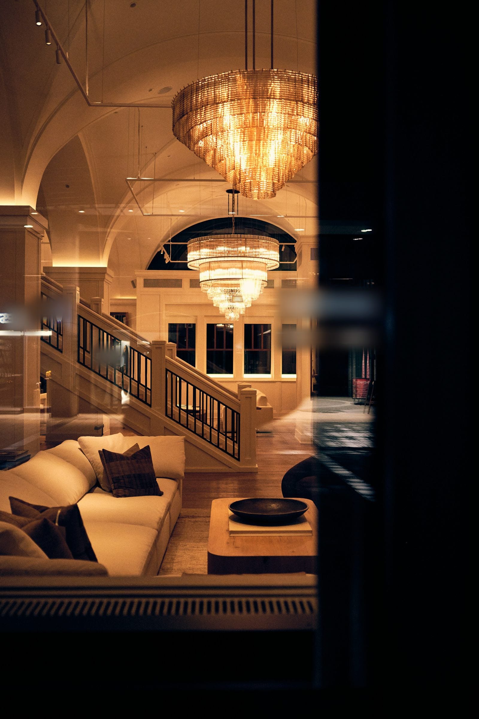 A palace lounge at night, crystal chandeliers lit.